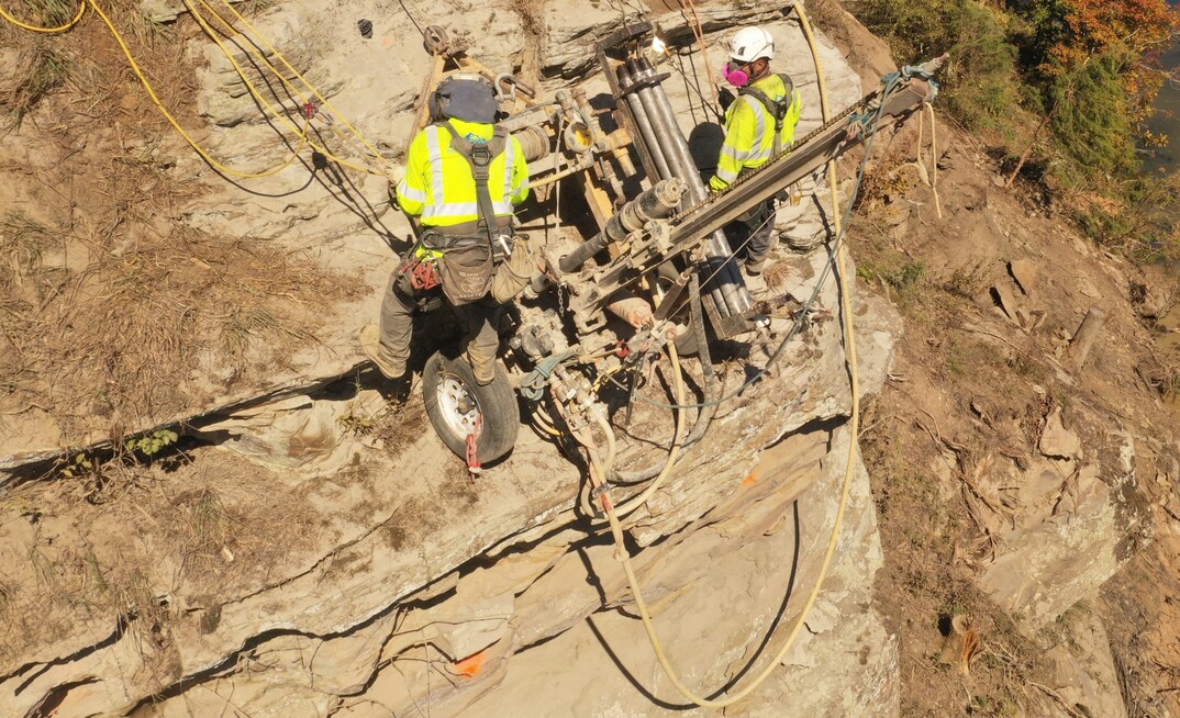 MSHA-certified crews worked six days a week using wagon drills and rope-access methods to scale the slope