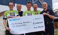 Kent Blaxill alpine cyclists present cheque to charity