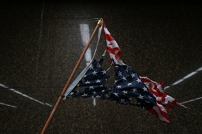 torn and burnt upside down merican flag hangs as protesters march through the streets of etroit ichigan for a second night ay 302020 protesting the killing of eorge loyd who was killed by a white officer who held his knee on his neck for several minutes during an arrest in inneapolis on onday hoto by