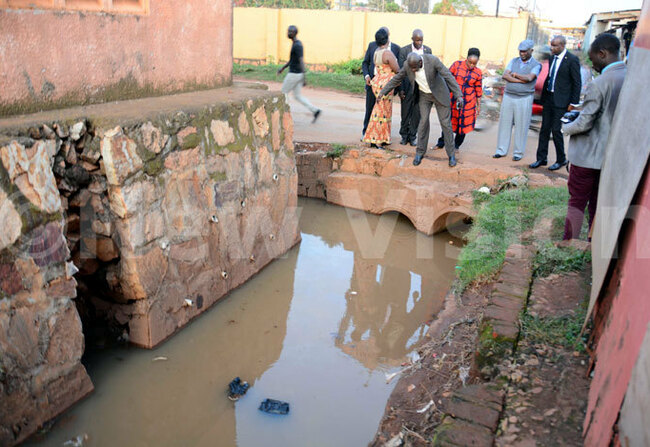  he minister of ocal overnment om utime with a hat inspects clogged water in a bridge on elcome to ireka oad in ira unicipality on ct 24 2018 hoto by rancis morut
