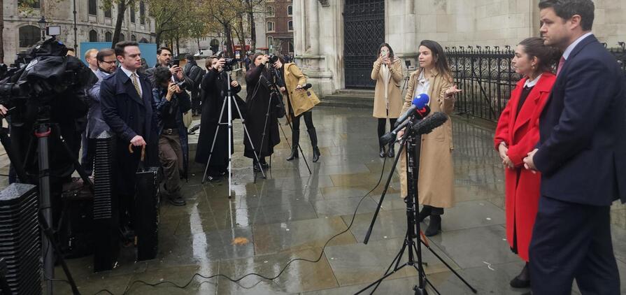 Caroline Narvaz Leite and Tom Ainsworth, from Pogust Goodhead, speak outside the High Court, London, today