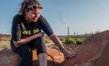 Raelene Cooper with a turtle petroglyph in front of North West Shelf