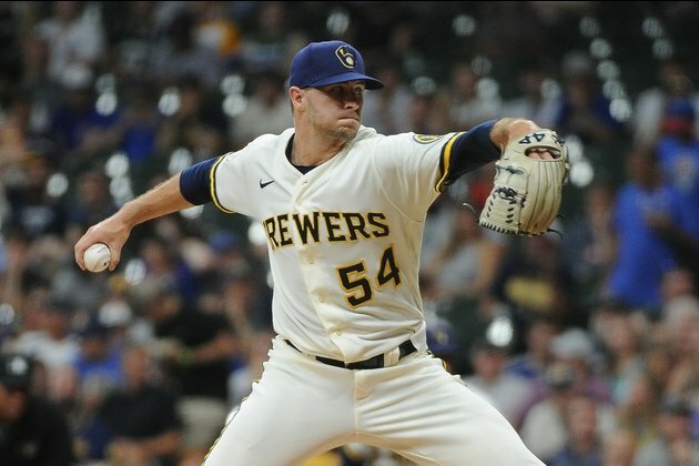 Trio of Brewers' relievers out due to COVID-19 issues