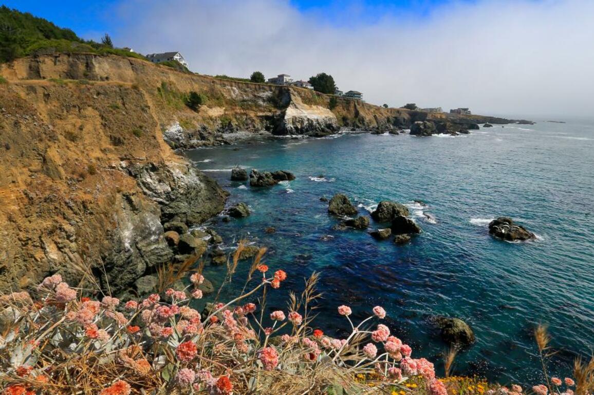 Hiker tumbles off California cliff, clings to life above ocean rocks