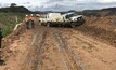  The roadway was wet and the vehicles were heading towards one another when one began to slide. 