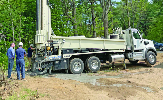 The Geoprobe DM650 air rotary drill rig provides time-saving features like backloading carousel and top head side shift