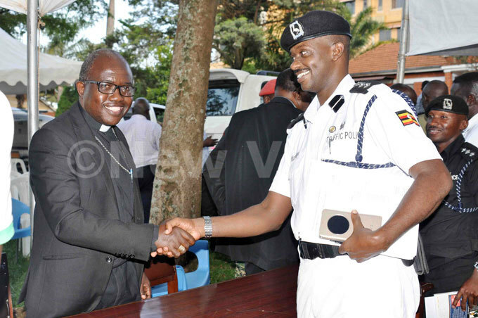  he traffic police commander in charge of ampala etropolitan area greets ishop incent irabo the bishop of oima diocese