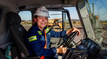 Ella Graham behind the wheel of a Cat haul truck at New Acland. Credit: New Hope Group