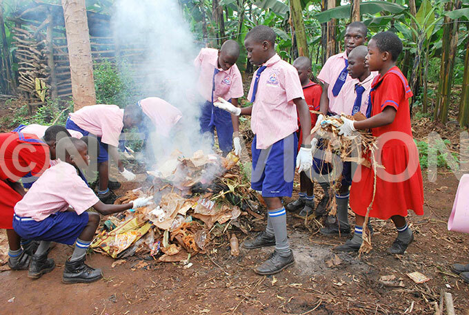 upils of ighfield rimary chool in ayaza ampala burning rubbish during a community sensitisation exercise on sanitation in the area in une 2014