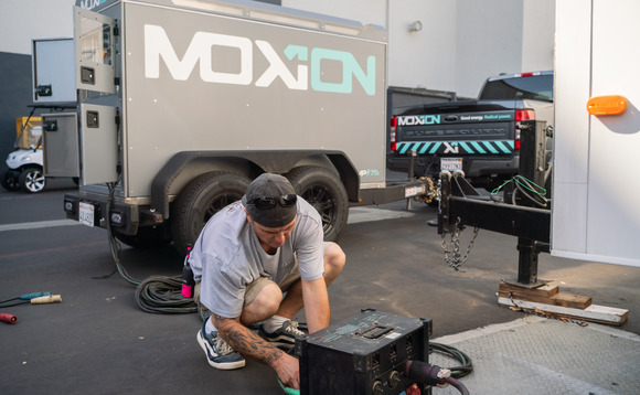 An Amazon Studios crew member plugs in a Moxion Power battery on the set of Amazon Studios film Sitting in Bars with Cake / Credit: Amazon