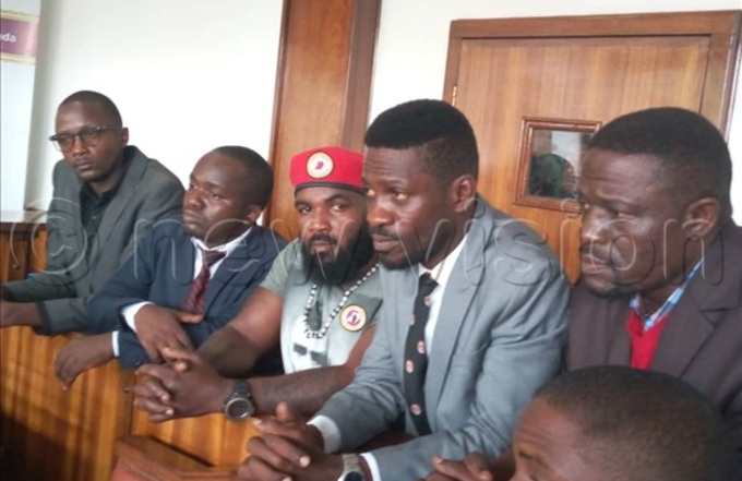 obi ine and coaccused in the dock at uganda oad ourt