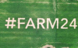 Giant #farm24 logo planted in field of maize 
