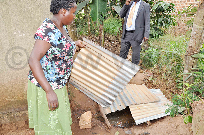 aruhaan ursery and rimary chool head teacher orothy amulondo inspects shoddy drainage which had a pool of urine hoto by ob antakiika