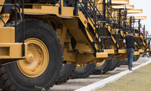 Potential buyers inspect trucks at a Ritchie Bros auction