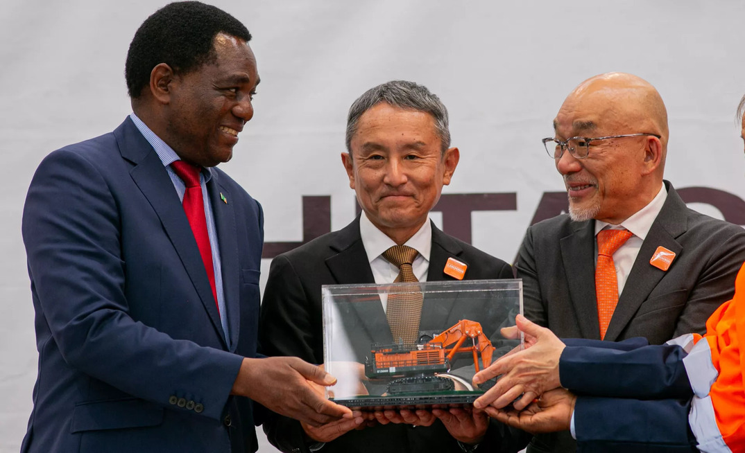 Zambian President Hakainde Hichilema of the Republic of Zambia, Hitachi Construction Machinery Zambia president Nobuhiko Saito,  and Eiji Fukunishi, Hitachi Construction Machinery’s mining business president