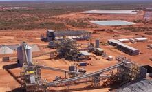  Processing plant with completed TSF and village in background. Photo taken October 14, 2022.