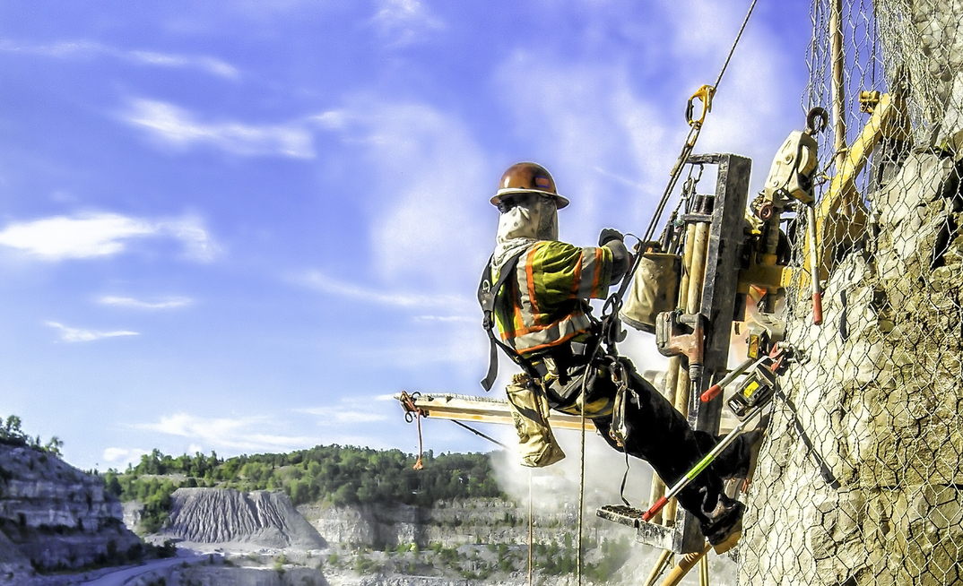 An example of the use of the mesh and bolting technique to stabilise a rock face at a quarry site. Credit: GeoStabilization International 