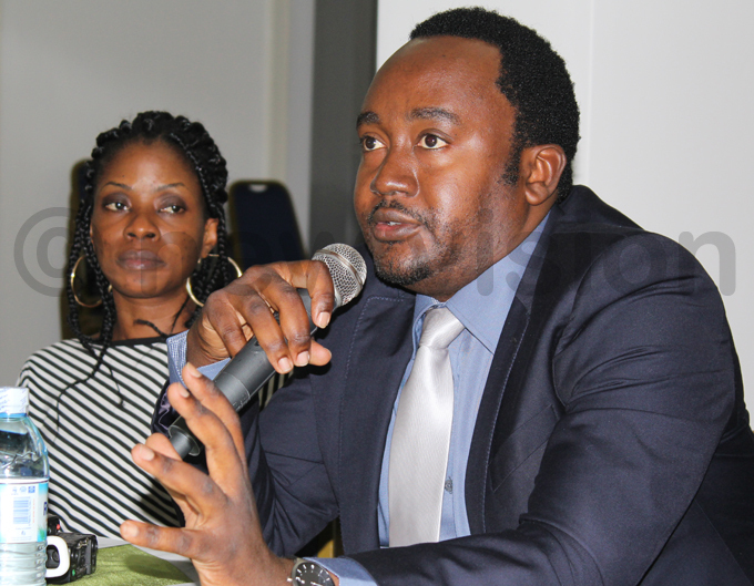 rispin aheru addresses at the launch of the survey while  deputy chairperson issy agaba looks on hoto by ancy anyonga