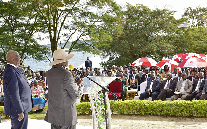 resident useveni addresses the congregation flanked by foreign affairs minister am utesa  hoto