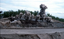  Clouds of dust rise as blasting occurs in an open cut mine, Newcastle