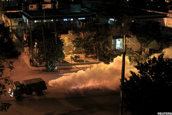   military truck carries out fumigation in a uban neighborhood to stop the breeding of the dengue mosquito in avana