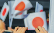 People with national flags in the park in Tokyo, Japan Credit: istock/ dimakig