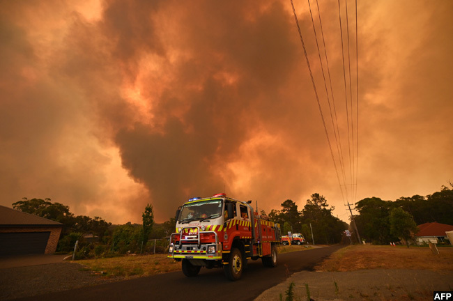  iretrucks were seen stationed on a road as a bushfire burnt in argo southwest of ydney on aturday