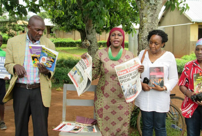  ajat ehmah asule  displaying some of the copies of the ew ision newspaper which she donated to akijju primary school  