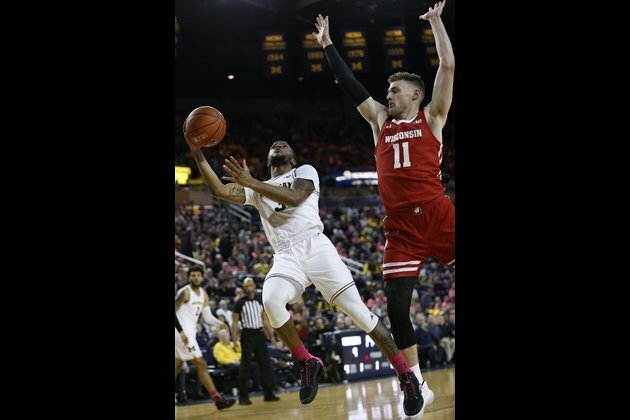 Visiting Wisconsin upsets No. 19 Michigan behind Trice's 28 points