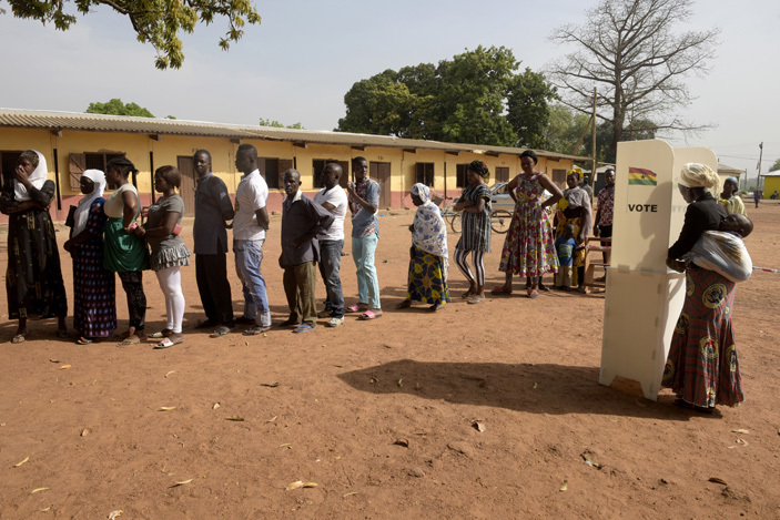   woman votes at a polling booth as people wait in line in the ole district northern region on ecember 7 2016      