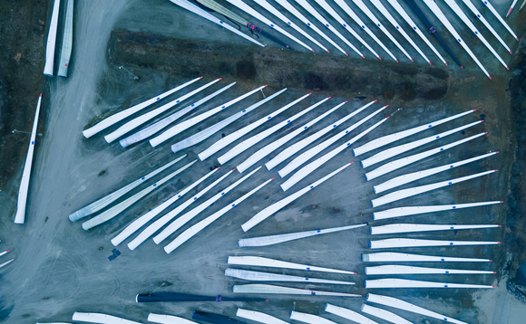 Blades for wind turbines stored outside of a factory waiting for shipping | Credit: iStock