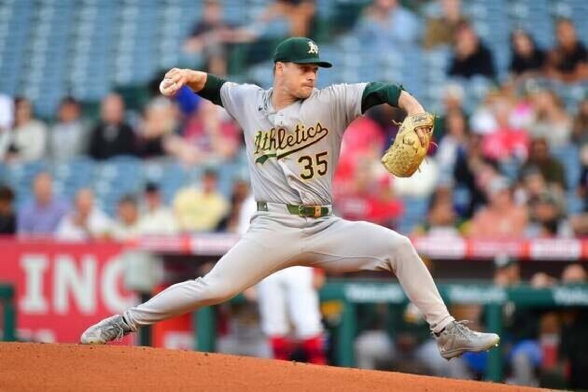 Angels, held hitless for eight innings, stun A's, J.T. Ginn