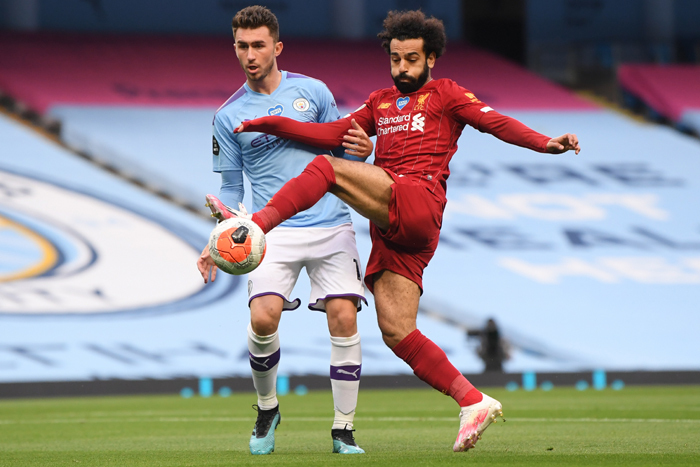 Manchester City's Aymeric Laporte (L) vies with Liverpool's Mohamed Salah 