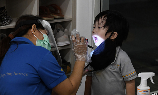 Back to school in masks as Singapore eases virus curbs Back to school in masks as Singapore eases virus curbs