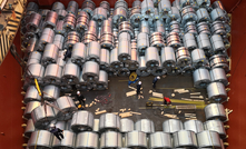 Steel coils loading in cargo hold of a bulk carrier by stevedores.