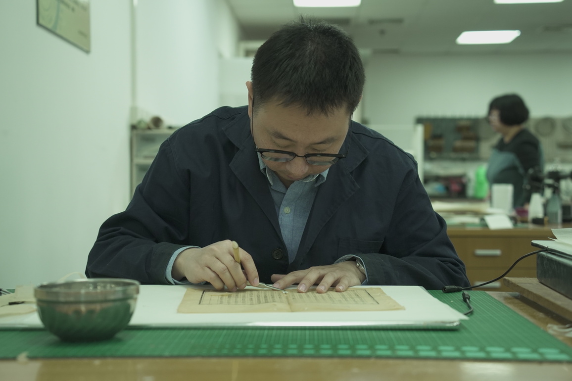 Between paper and pixels, a library repairs what time wears down