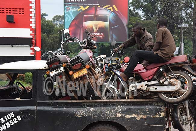  oda boda motor cycles towed away by a break down car after the olice held a 20 minute crackdown on boda boda riders for overloading hoto by palanyi sentongo 