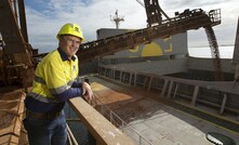 Mal Briggs, Alcoa's vice president mining operations, looks on as the first bauxite is loaded for export to China.