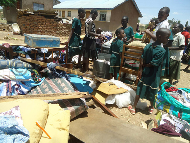  upils of amba look on some of teachers property thrown out of the houses after the eviction hoto by mmanuel pio