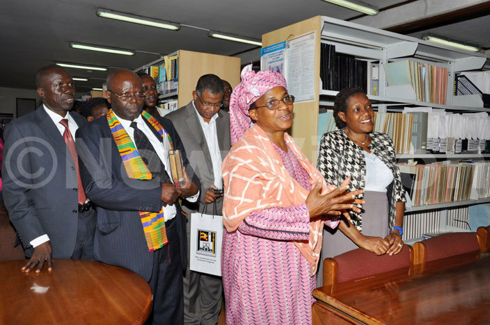  rs auline azrui  and her delegation inspect arliaments library  with lerk to  arliament ane ibirige 