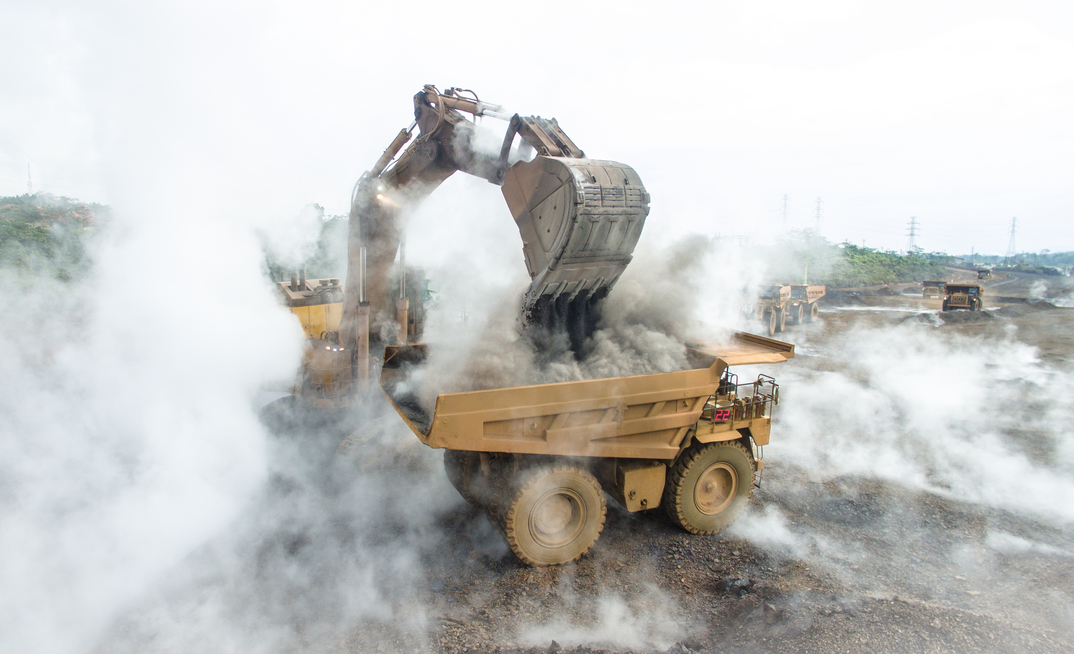 Backhoe load warm and smokey slag material into mining dump truck in Nickel Mining in South Sulawesi, Indonesia. Credit: Shutterstock.