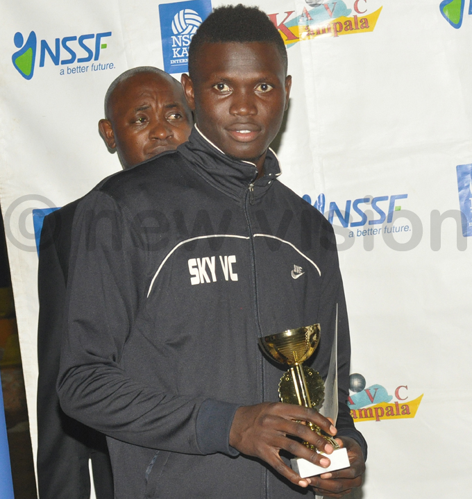 ky olleyball lubs athbart alinga poses with the  trophy hoto by ichael subuga