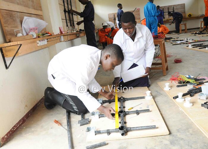  raise orcas hora 14 years student of amugongo secondary and vocational school being assessed by ilda usenero in the electric installation his was at during the implementation of   the dual curriculum in secondary schools hoto by amadhan 