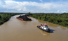 Samarinda, Indonesia: Tugboats tow coal barges on the Mahakam tributary.