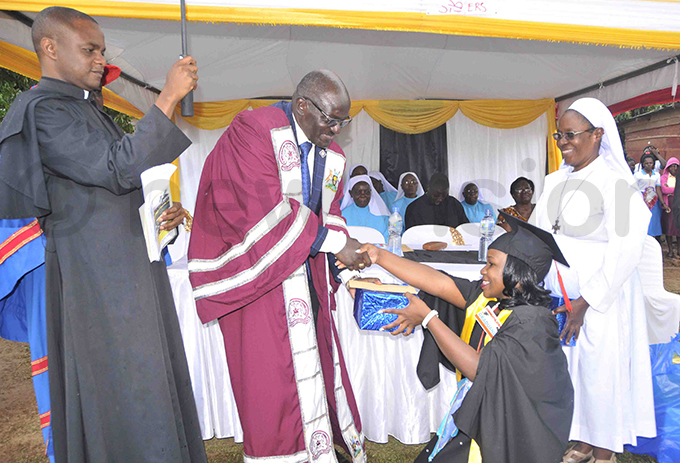 en atumba awarding one of the best students during the graduation ceremony hoto by enry subuga