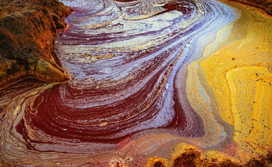 A palette of colors produced by the various metals extracted through mining and bacterial activity in the acidic waters of the river Tinto at its headwaters.
