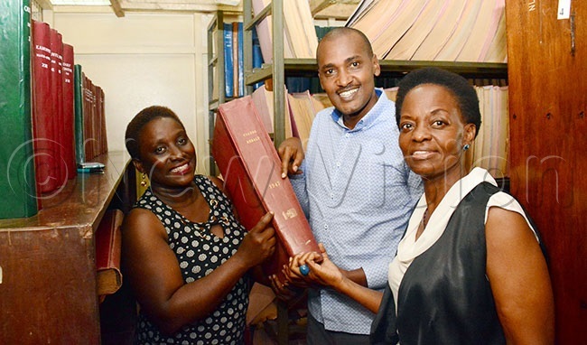  ellen uyombaleft head of information and reference services and tella ekuusa a enior rincipal ibrarian showing gender minister rank umwebaze a copy of the ganda erald newspaperhoto by ddie sejjoba
