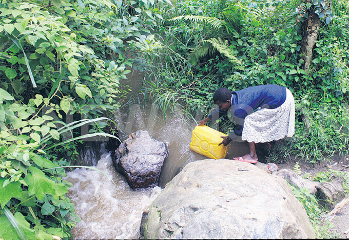  woman with a hearing impairment fetching water from iver panga