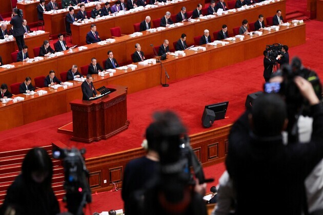 China to boost military spending by 7%; slashes annual economic growth target