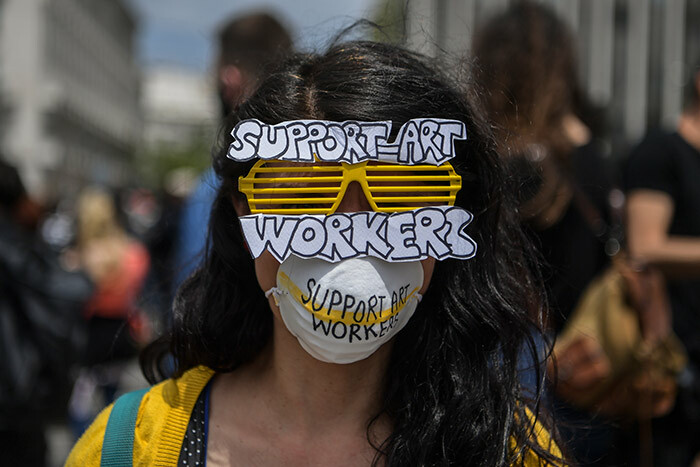 reek artist and member of an artist union wears a mask and protective facemask as she demonstrates with others in front of the reek parliament at yntagma square in central thens on ay 7 2020 during a rally organised by artists musicians and actors to ask for help to the reek government for the financial loses due to the lockdown aimed at curbing the spread of the 19 the novel coronavirus hoto by